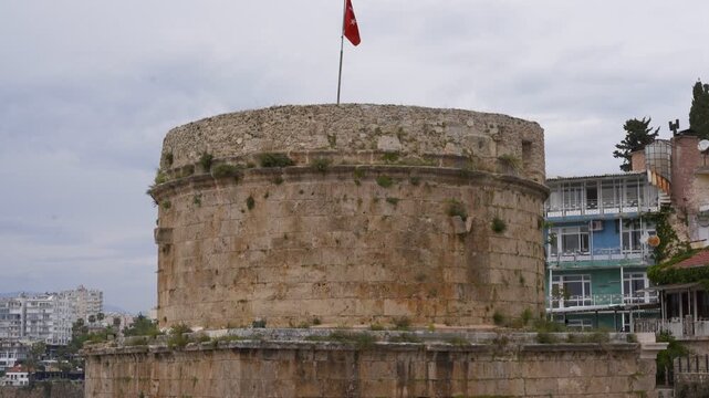 Hidirlik Tower with Turkish flag waving in Antalya, Turkey