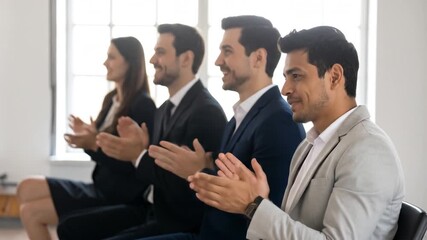 Group of diverse professionals applauding in a modern office setting