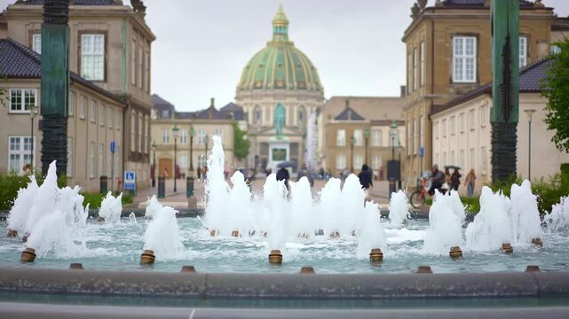 Fountain in front of Amalienborg Palace in Copenhagen, Denmark, the official winter residence of the Danish royal family. Historic travel  landmark, Scandinavian tourism destination in Europe.