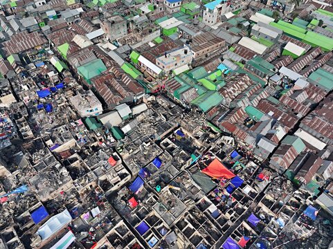 Dhaka, Bangladesh - 28 November 2025: Aerial view of The Korail slum shows a stark contrast between vibrant rooftops and the charred remains of a recent fire..