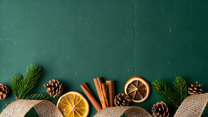 Festive Decorations: An inviting composition featuring winter accents, dried oranges, cinnamon sticks, pinecones, and evergreen branches, arranged over a beautiful surface.