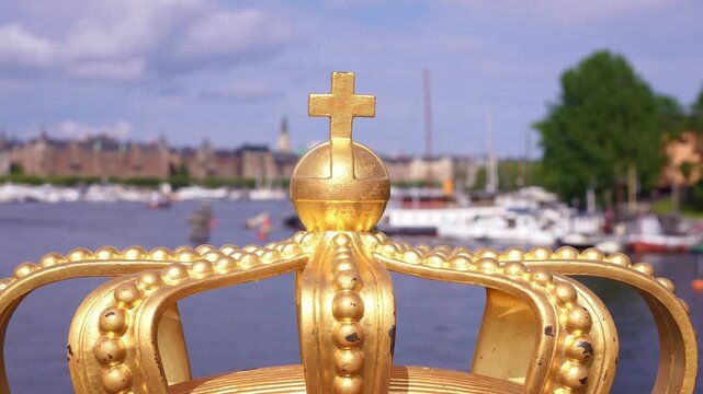 Stockholm bridge with famous royal crown, offer iconic views of the city, Royal Palace and Gamla Stan. Historic landmark in capital of Sweden. Scandinavian travel tourism destination in Europe.