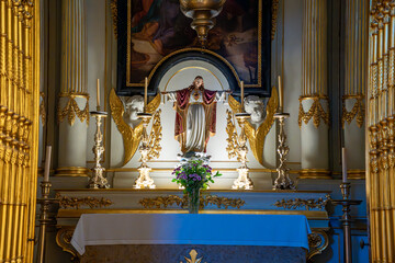 Statue of the Sacred Heart of Jesus prominently displayed on the altar of the Christian church of S&atilde;o Sebasti&atilde;o da Pedreira in Lisbon.