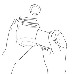 close up of hands peeling a label off a bottle.