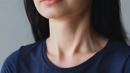 Close-up view of a young woman's neck and chin, showcasing healthy skin and elegant posture, emphasizing natural beauty and a serene appearance