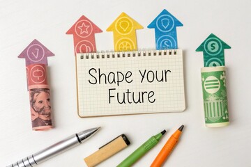 Notebook with shape your future text and colorful arrow cutouts