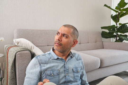 Man contemplating problems inside a modern living room