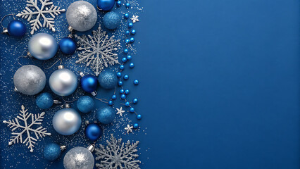 Elegant blue and silver christmas baubles and snowflakes on a deep blue festive backdrop