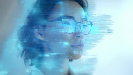 Confident young woman with glasses looking thoughtfully ahead, illuminated by futuristic digital interface graphics. Modern technology and innovation concept in a professional setting - Powered by Adobe