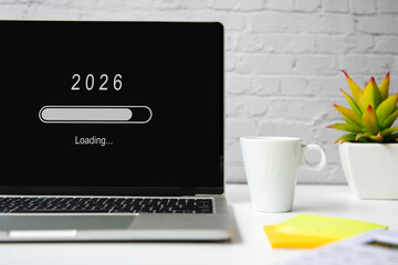 Loading year 2026 for start new business and new life. Equipment working in office with coffee drink.  New Year Concept
