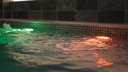 Captivating Underwater Show A Symphony of Colors and Splashes in a Lit Swimming Pool at Night Showcasing Dynamic Water Movement and Vibrant Reflections. - Powered by Adobe