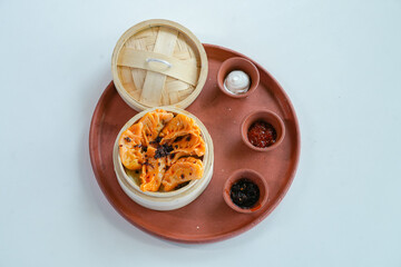 Steamed Momos in Bamboo Basket with Dipping Sauces
