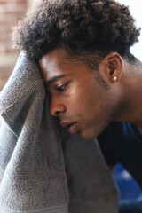 Black African American man with short curly hair using a towel. Close-up of a person with a towel....