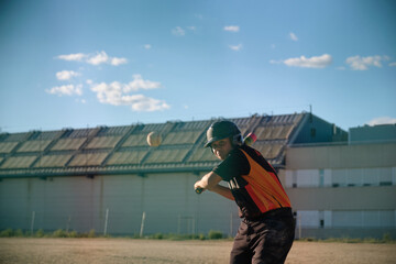 Boy batter hitting baseball, actively playing during a practice session