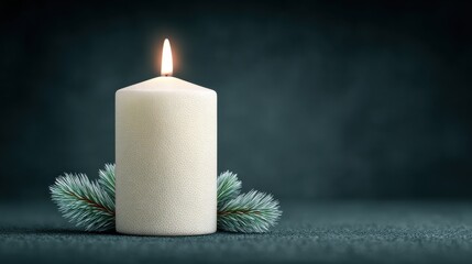 A candle is lit on a table with pine needles