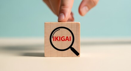 Ikigai concept hand points to wooden block with magnifying glass