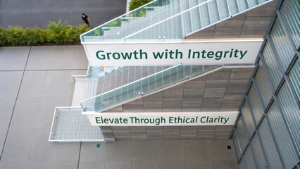 Inspirational words on building stairs showcasing values of growth, integrity, and ethical clarity in modern architecture and design
