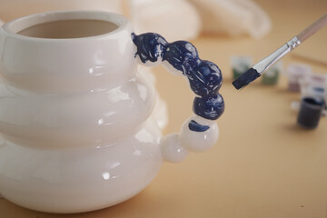 Ceramic mug being hand-painted in a creative workshop