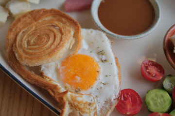 Delicious breakfast with a sunny side up egg and pastries