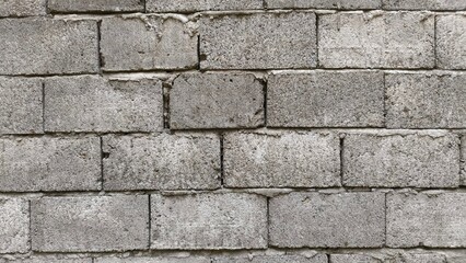 Obraz premium Gray brick wall texture perfect for backgrounds, architecture design, industrial themes, and creative visual projects.