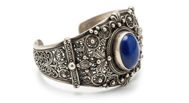 Close-up of an ornate silver cuff bracelet with a large blue gemstone on a white - Powered by Adobe