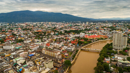 drone aerial of Chiang Mai Thailand cityscape old town temples mountains and ping river, travel destination 
