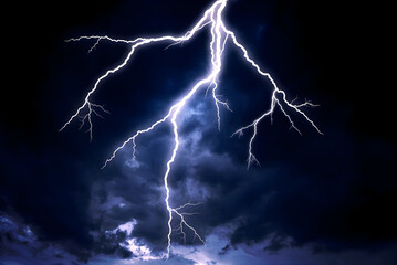 Powerful Bright Lightning Bolt Striking Down from Dark Stormy Night Sky
