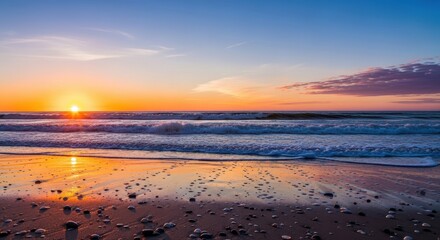 Obraz premium Golden hour serenity: Beach coastline bathed in warm light and tranquil waves