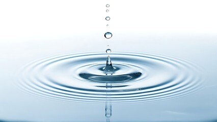 Water droplets falling into a pool creating ripples on a white background in a studio shot