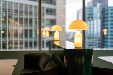 Warm modern table lamp glows contemporary office lounge city backdrop
