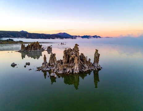 Aerial view of unique rock formations in a tranquil lake at dawn - Powered by Adobe