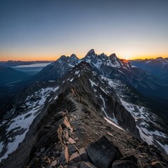 Majestic mountain range vista during early morning with sunlight and rocky terrain