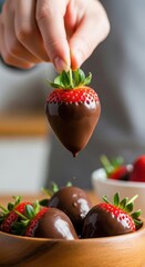 Elevated chocolate dipped strawberry against backdrop suggesting kitchen environment delicious treat