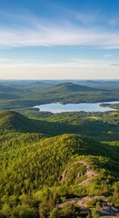 Lush mountain terrain with serene lake under vast sky creating peaceful visual