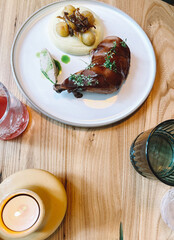 Delicious roasted chicken with side dishes and garnishes on a wooden table