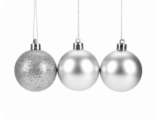 Three Silver Christmas Ornaments Hanging in a Row on a White Background
