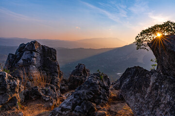 Dramatic Sunset View from Mountain Top with Rugged Rocks