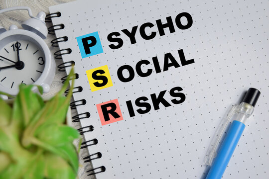 Concept of PSR - Psycho Social Risks write on book isolated on Wooden Table.