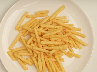 Potato stick crunchy snacks isolated on white background 