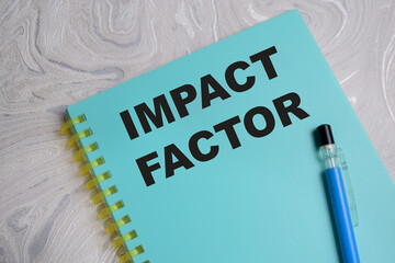 Concept of impact factor write on book isolated on Wooden Table.