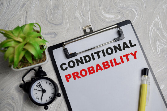 Concept of conditional probability write on clipboard isolated on Wooden Table.