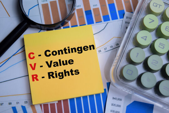 Concept of CVR - Contingen Value Rights write on sticky notes with financial graphs isolated on Wooden Table.