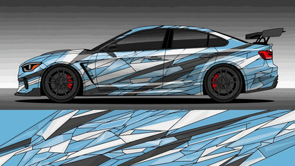 Side profile of a modern sports car with a blue, white, and grey abstract geometric vinyl wrap design.