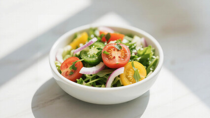 Fresh salad with colorful tomatoes, red onion, and arugula in a white bowl