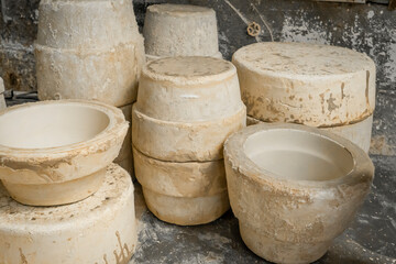 The artist paints a ceramic mug