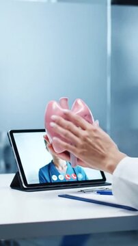 Doctor Demonstrating Thyroid Anatomy on Video Call with Pink Model in Clinic Setting on White Table for Medical Education and Health Awareness Initiatives in Well Lit Environment
