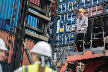 Caucasian logistic worker on reach stacker vehicle