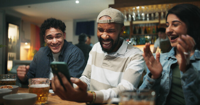 Winning, friends and celebration with phone in pub for streaming match, sports goal and team support. Football fans, people and smartphone with success in bar for game score, live broadcast or event