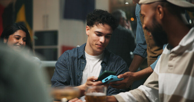 People, payment and pos machine with phone in pub for purchase, banking or drinking in club. Man, friends and paying bill with mobile smartphone, NFC or app for beer, alcohol or beverage in bar