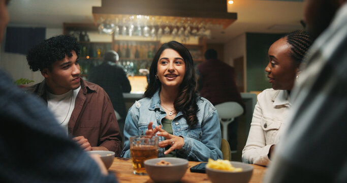 Conversation, friends and people in pub, alcohol and bonding together with reunion. Group, men and women in restaurant, discussion and laughing with joke, beverage and social gathering with happiness - Powered by Adobe